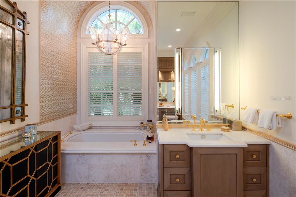 elegant bathroom with soaking tub over looking the window