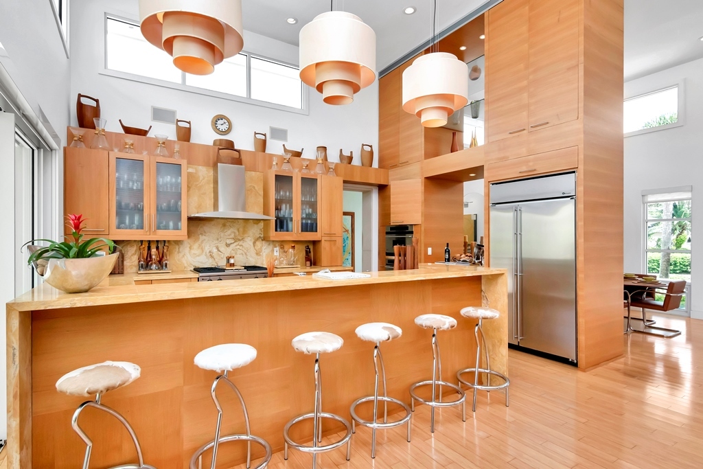 Photo of Luxury kitchen with barstools and handing light fixtures