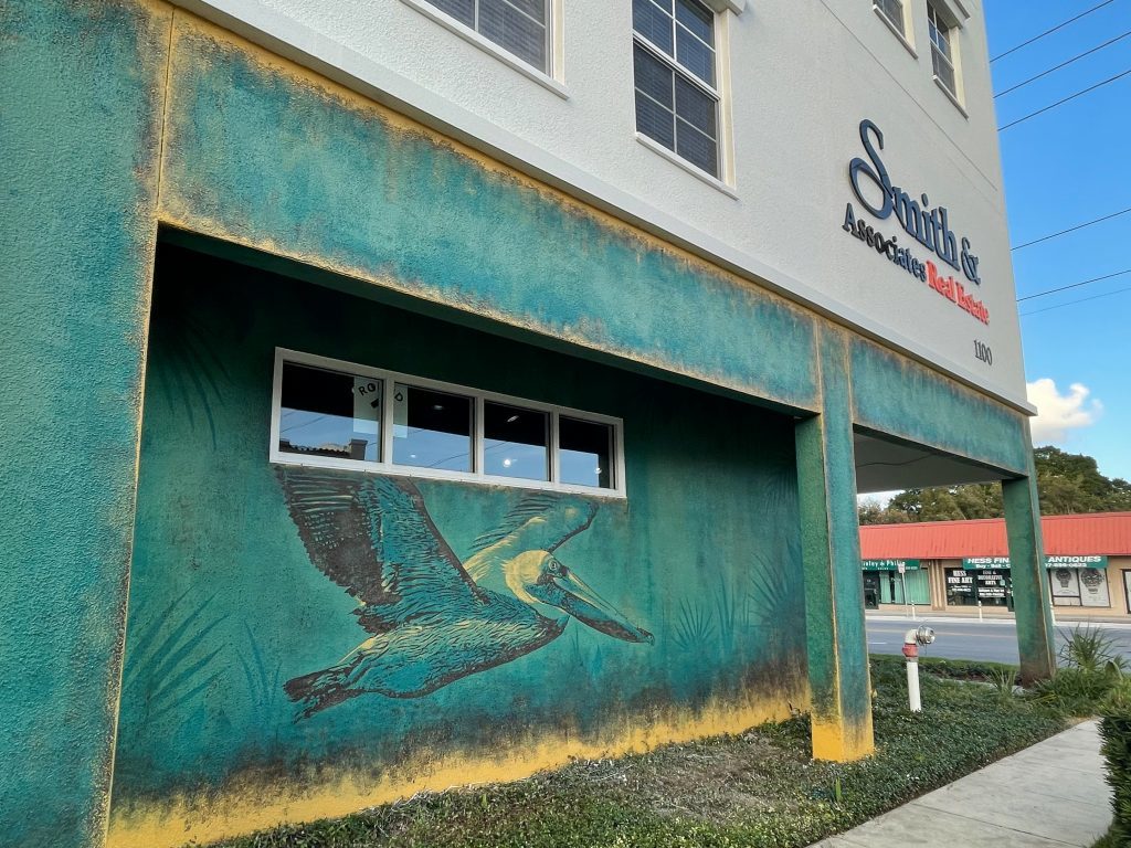 Photo of Smith & Associates Real Estate's 4th Street office with green mural on the wall