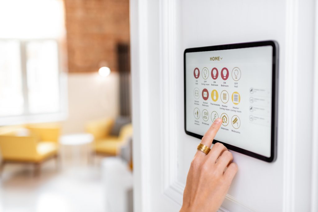 Controlling home with a digital touch screen panel installed on the wall in the living room